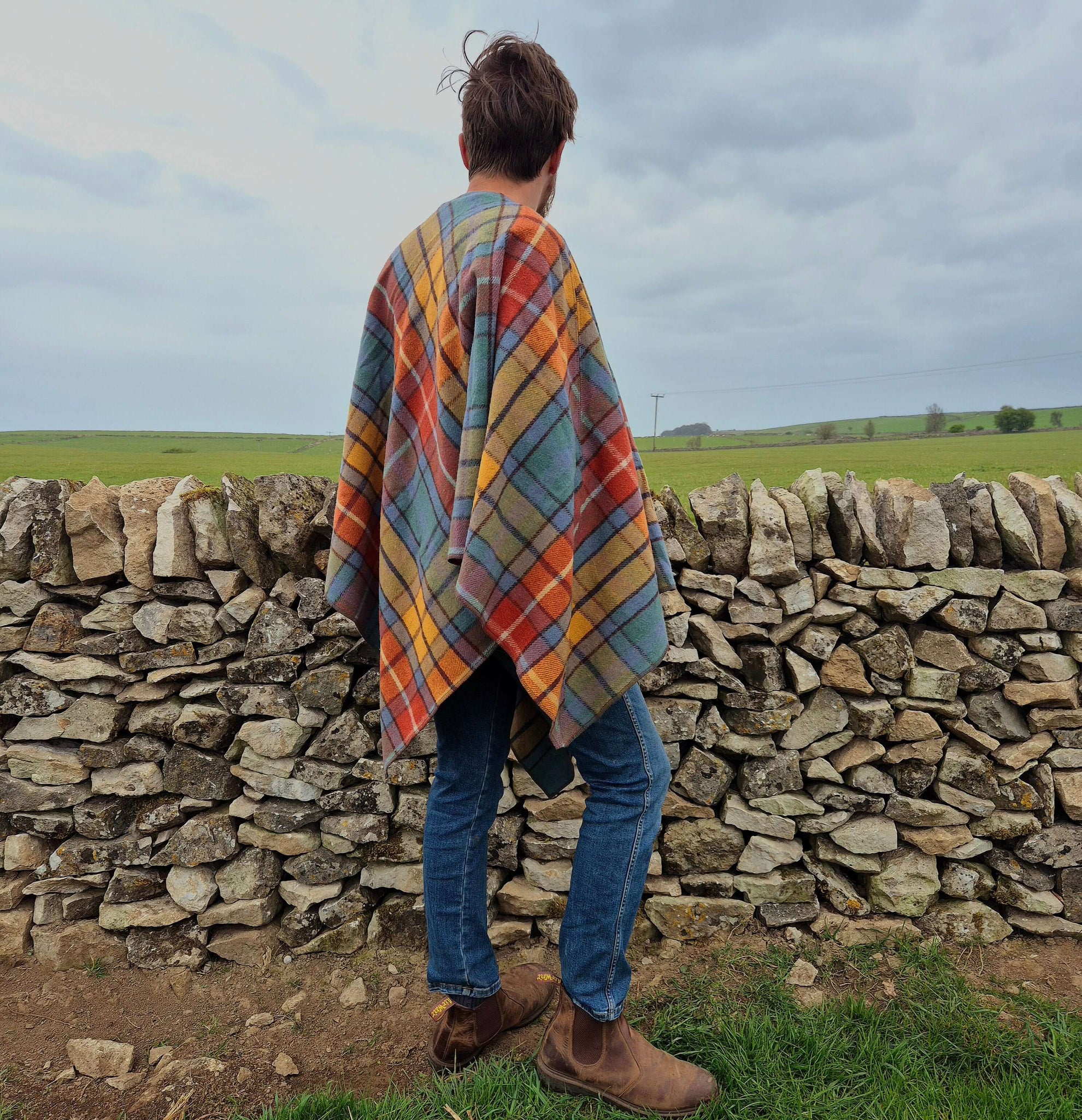 Cozy wool poncho in vibrant plaid patterns, perfect for cool evenings and breezy days.