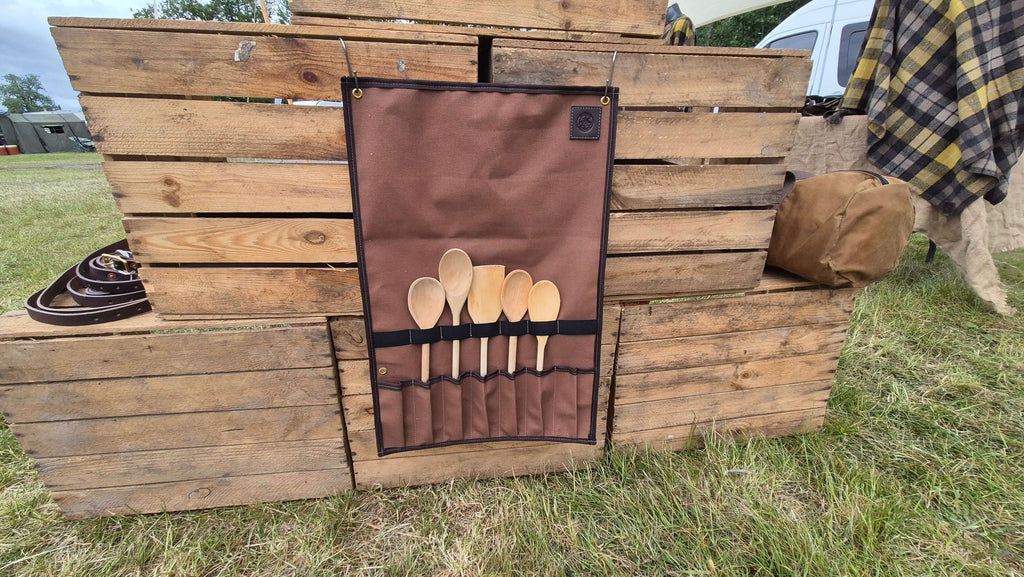 Camp Cookup Toolroll displaying wooden utensils organized and ready for use on a wooden pallet backdrop.