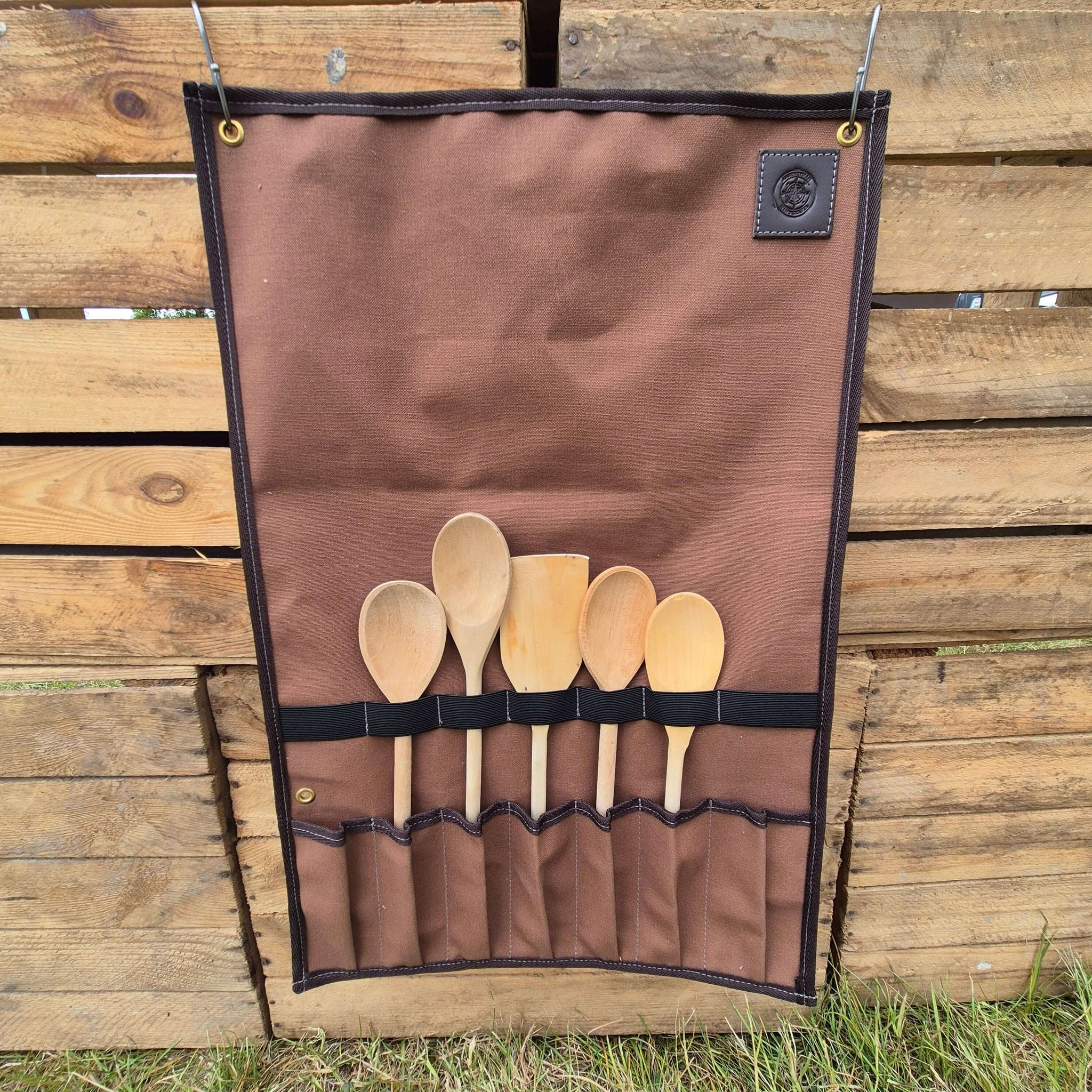 Camp Cookup Toolroll displaying wooden utensils, perfect for keeping your cooking tools safe and organized outdoors.