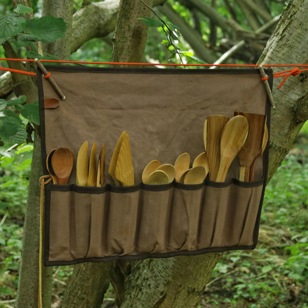 Brown canvas tool roll with wooden utensils