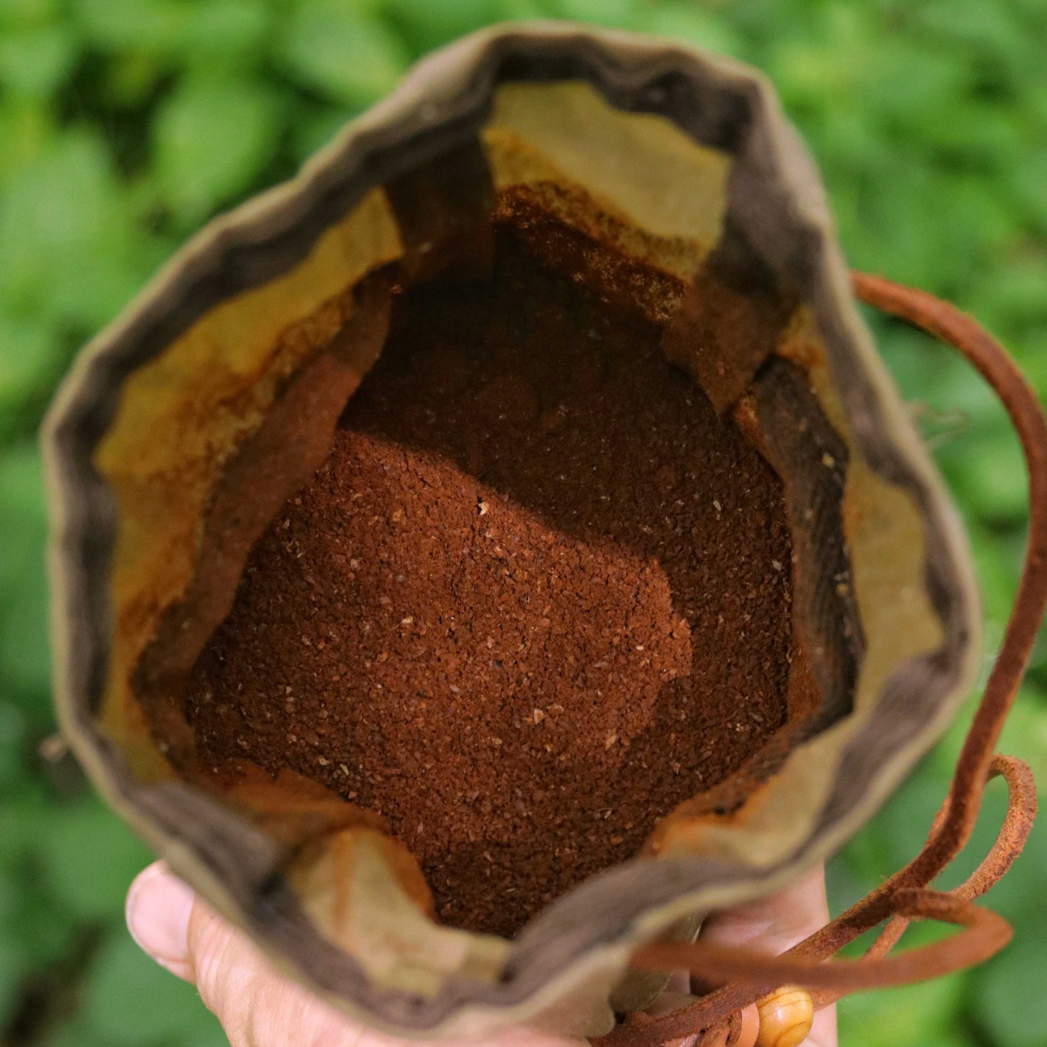 Freshly ground coffee in a wax canvas coffee pouch