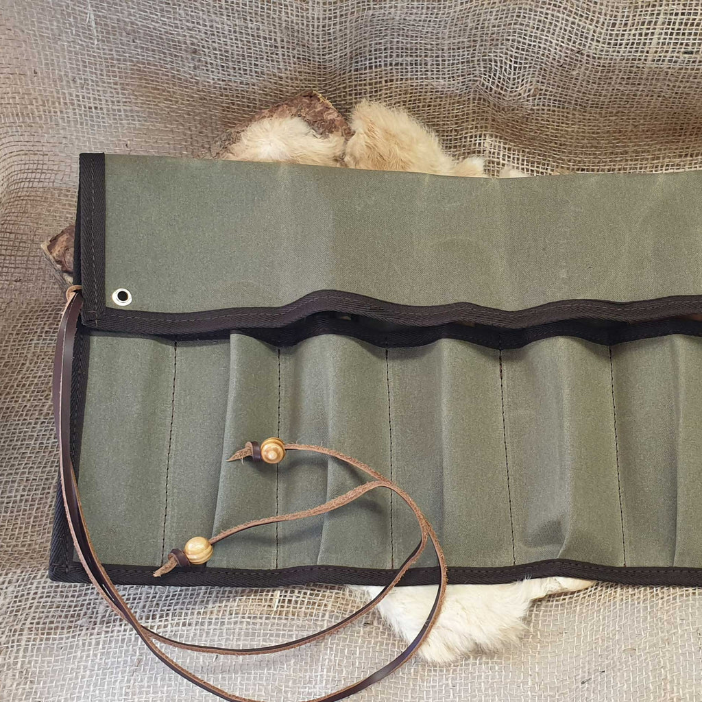 Folded green canvas tool roll