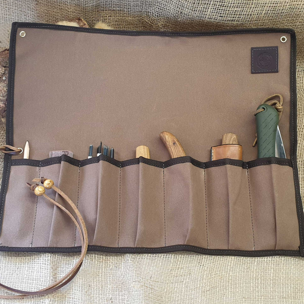 Brown canvas tool roll holding hand tools.