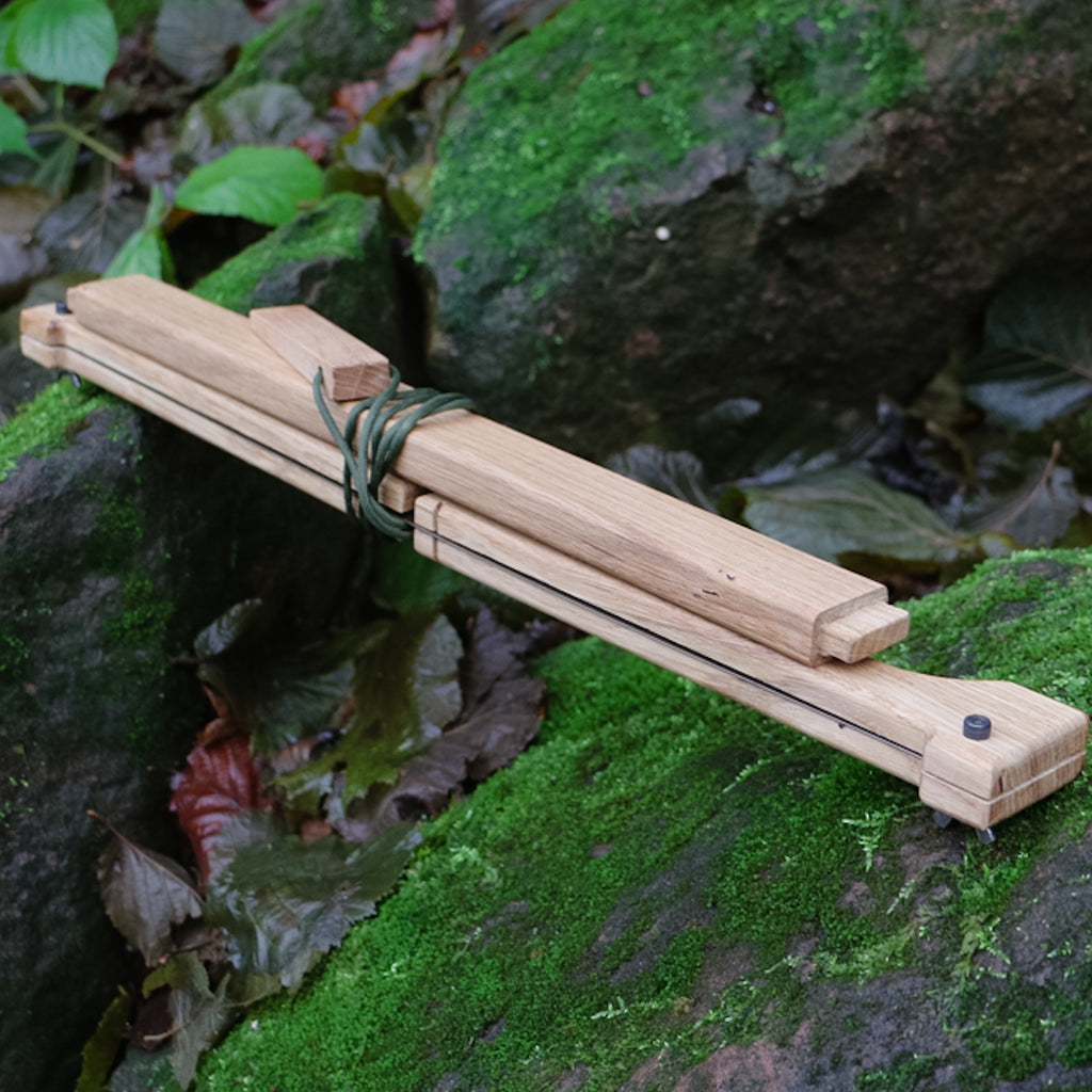 A folded wooden bucksaw